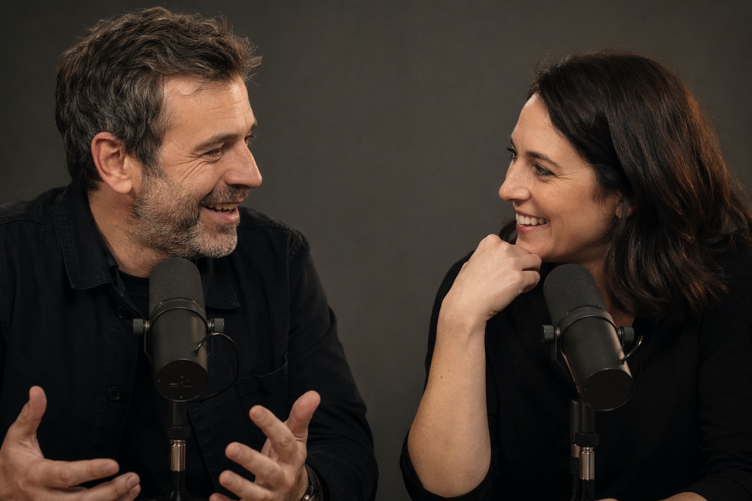 Executive recording a corporate podcast on the pre-lit studio set with an engineer on cameras
