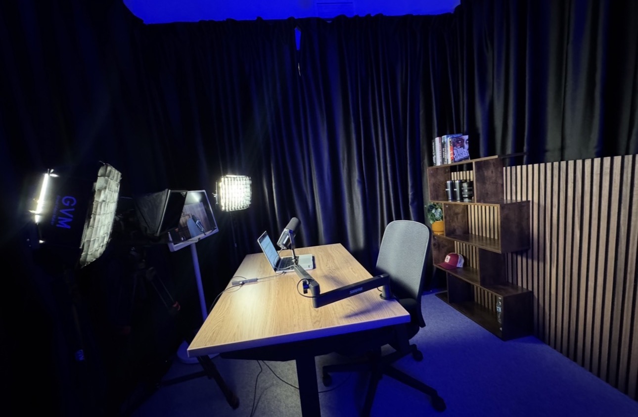 Course and teleprompter recording area with desk, teleprompter, and lighting