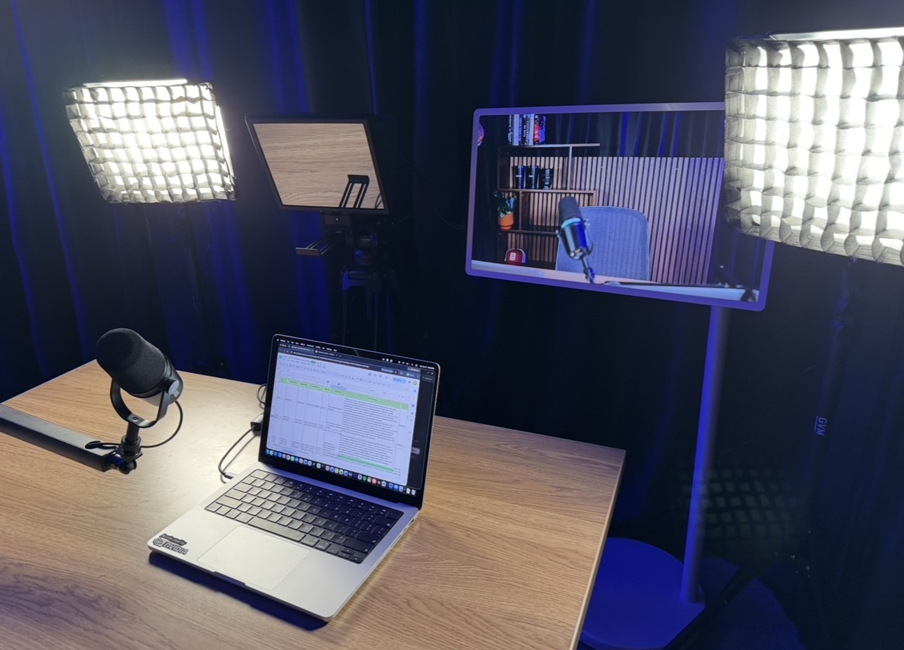 Teleprompter, confidence monitor, and broadcast mic at the course desk